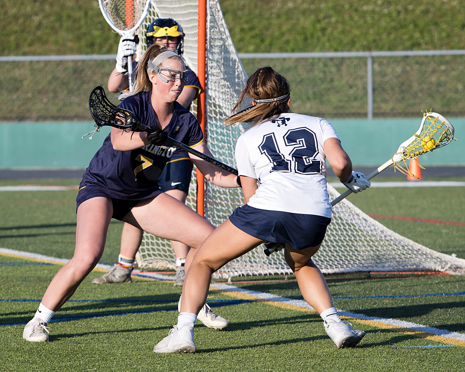 Amy LaBelle forces a Moses Brown opponent away from the goal during the first half of the Division 1 girls lacrosse championship game.
