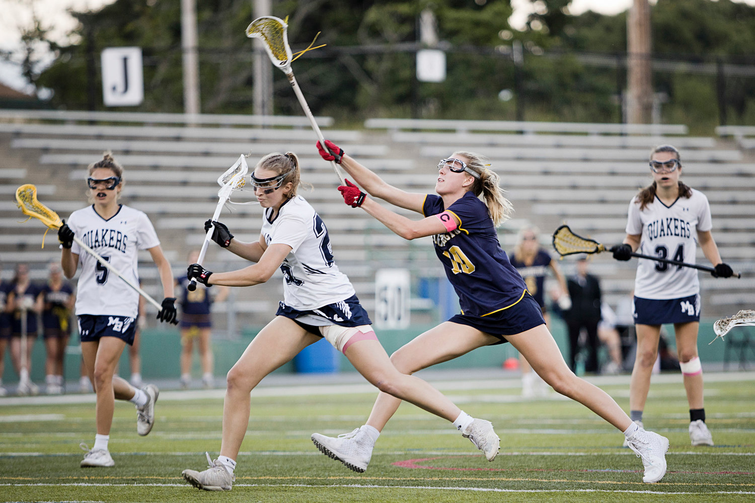 Senior captain Kate Robertson runs down a Moses Brown opponent with a stick-check from behind.