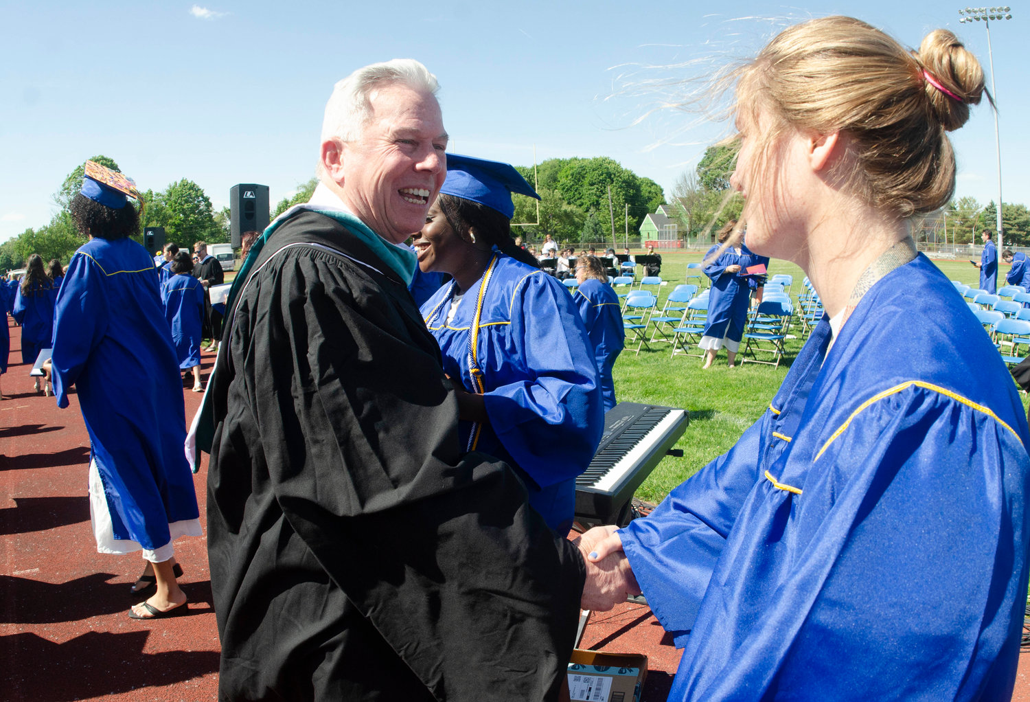 Barrington High School Principal Joe Hurley shakes a student’s hand following the graduation ceremony at Victory Field on Sunday, June 5.
