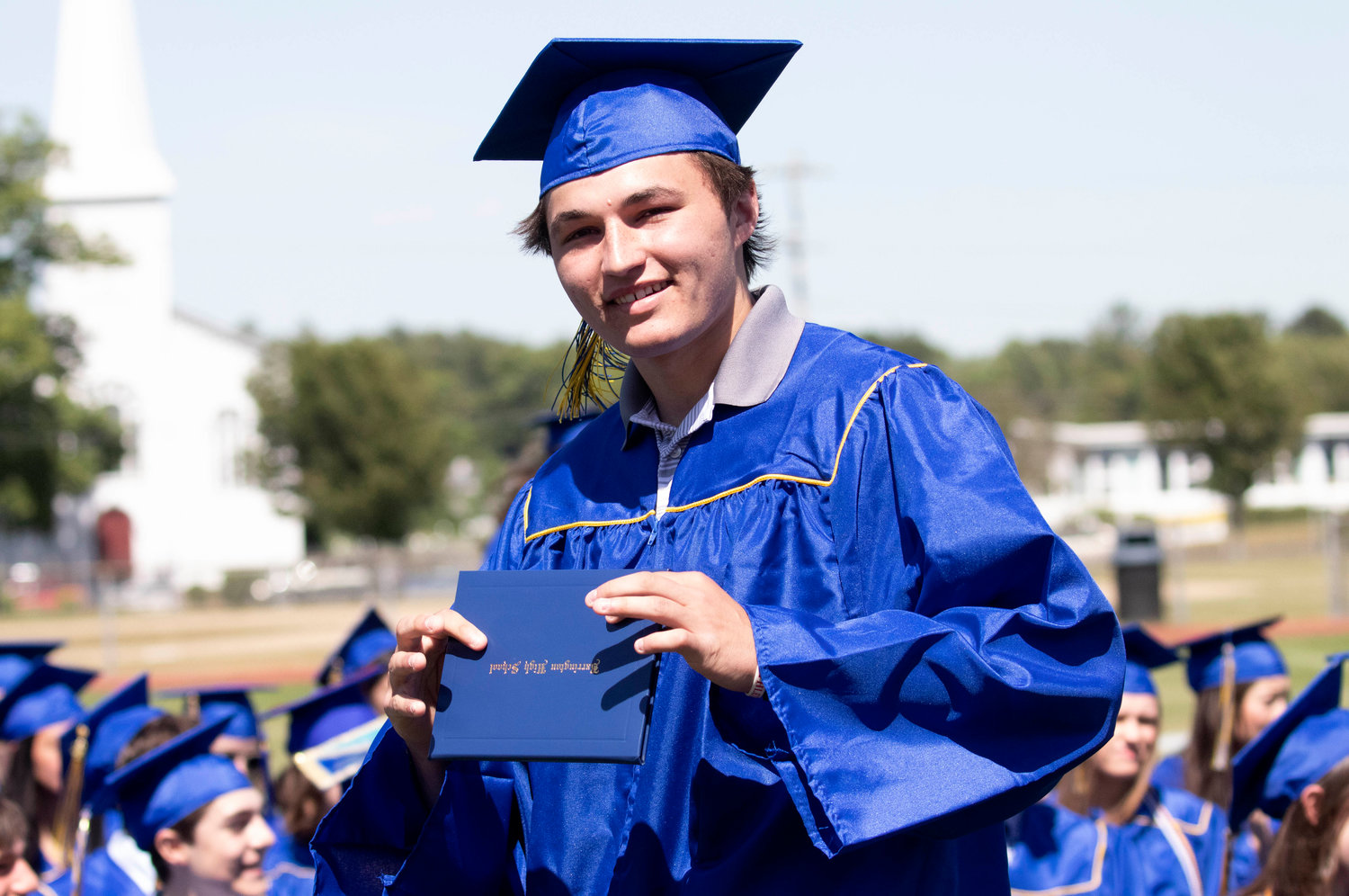 James Anderson shows off his diploma during the graduation ceremony at Victory Field on Sunday, June 5.