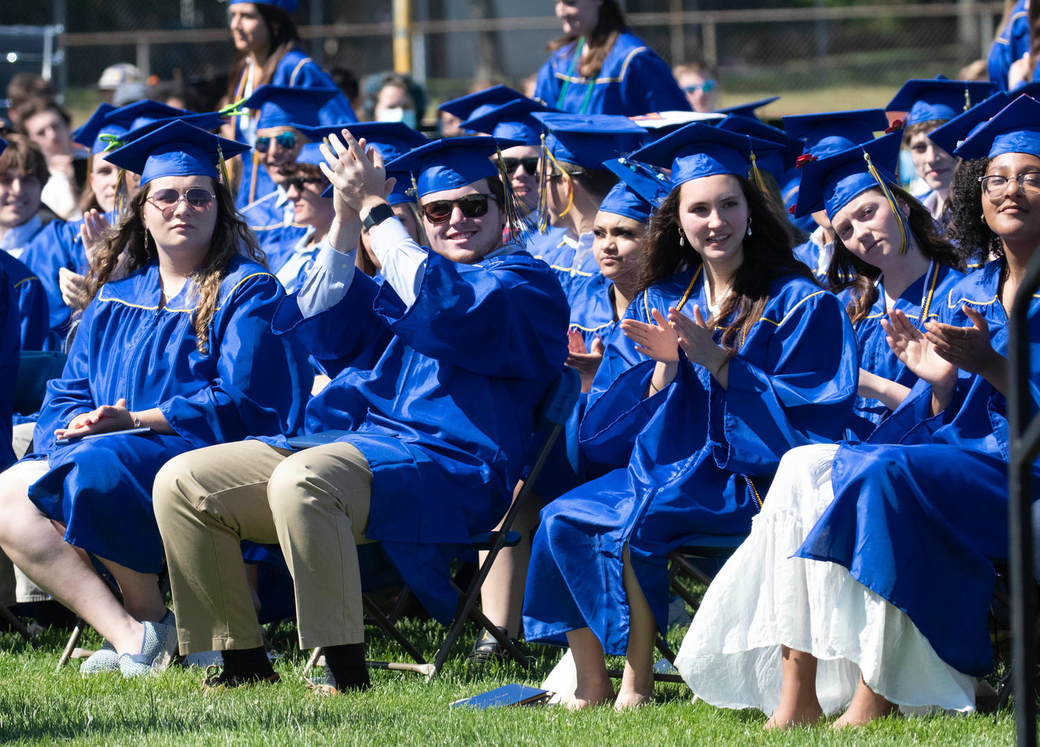 Barrington High School graduates cheer for a classmate during the graduation ceremony at Victory Field on Sunday, June 5.