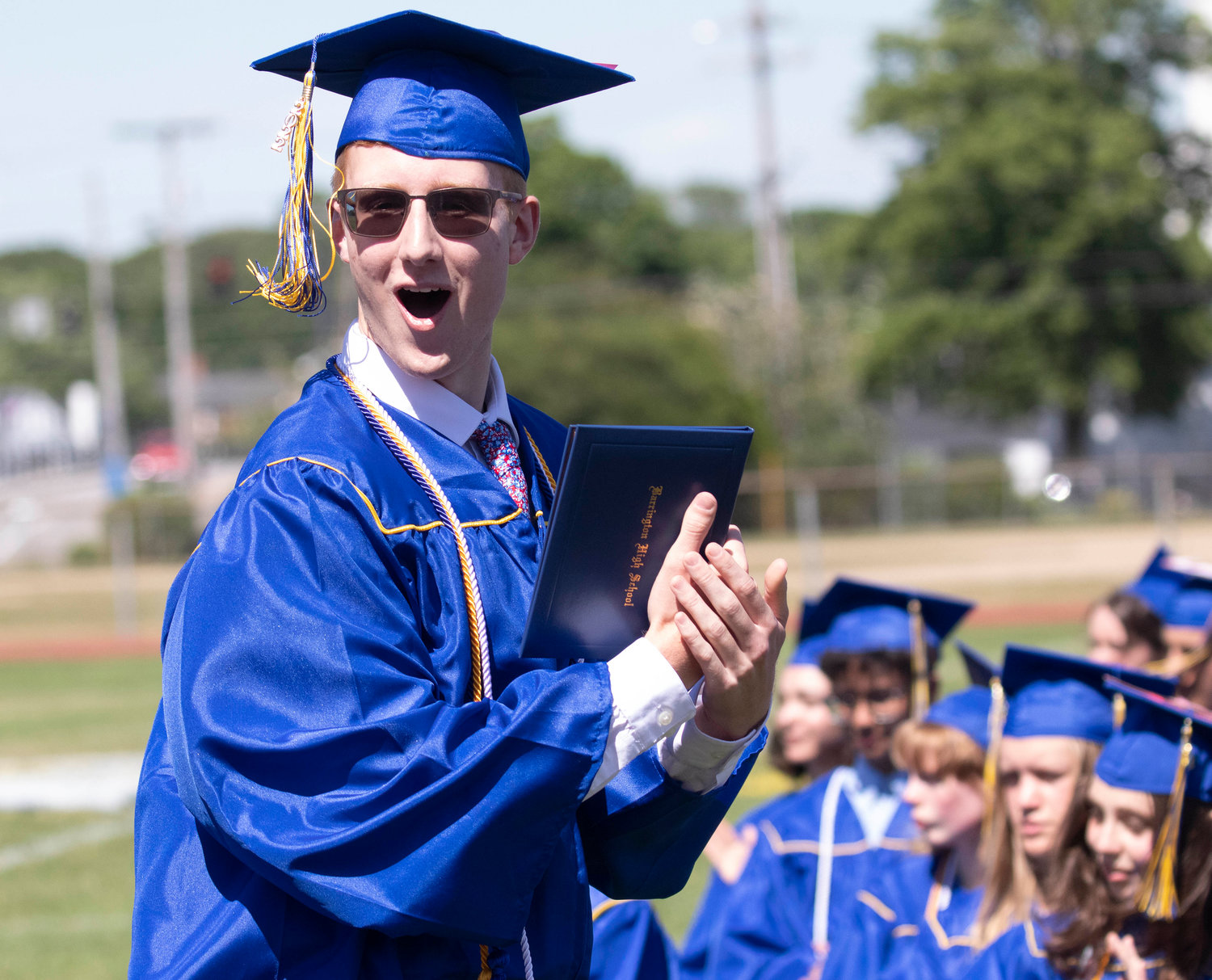 Lucas Matthews cheers after receiving his diploma during the graduation ceremony at Victory Field on Sunday, June 5.