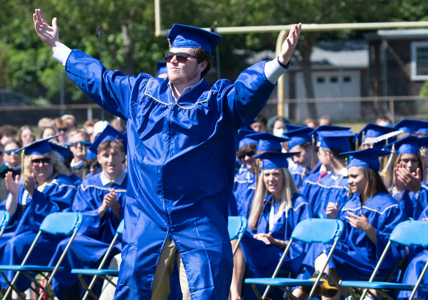 Garrett Lepore raises his hands in the air during the graduation ceremony at Victory Field on Sunday, June 5.