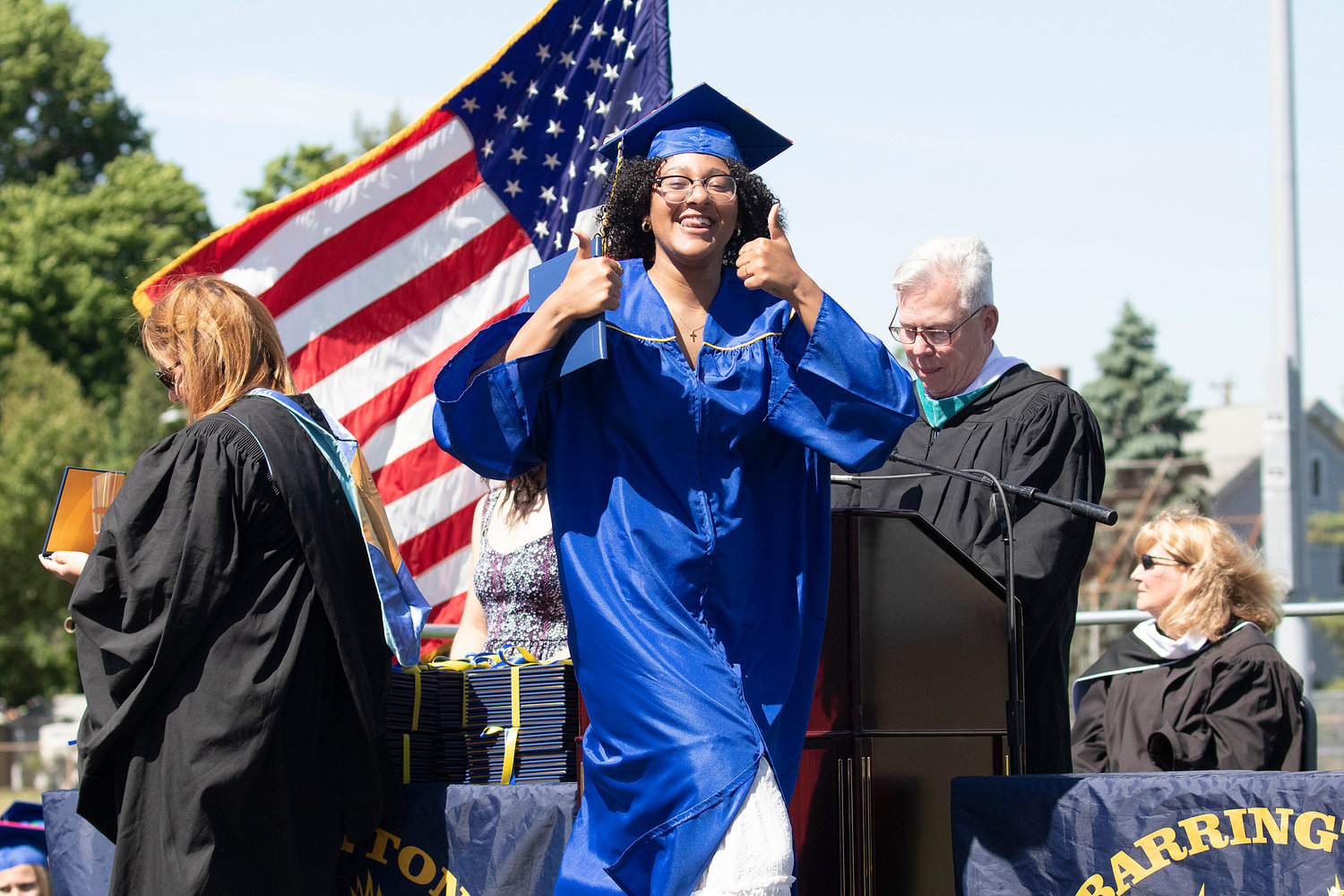 A Barrington High School graduate shares two thumbs up after receiving her diploma during the ceremony on Sunday.