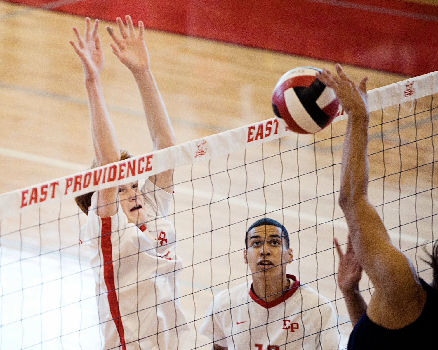 East Providence High School’s Kyle Dunn jumps to block the net as Grant Wosencroft looks on.