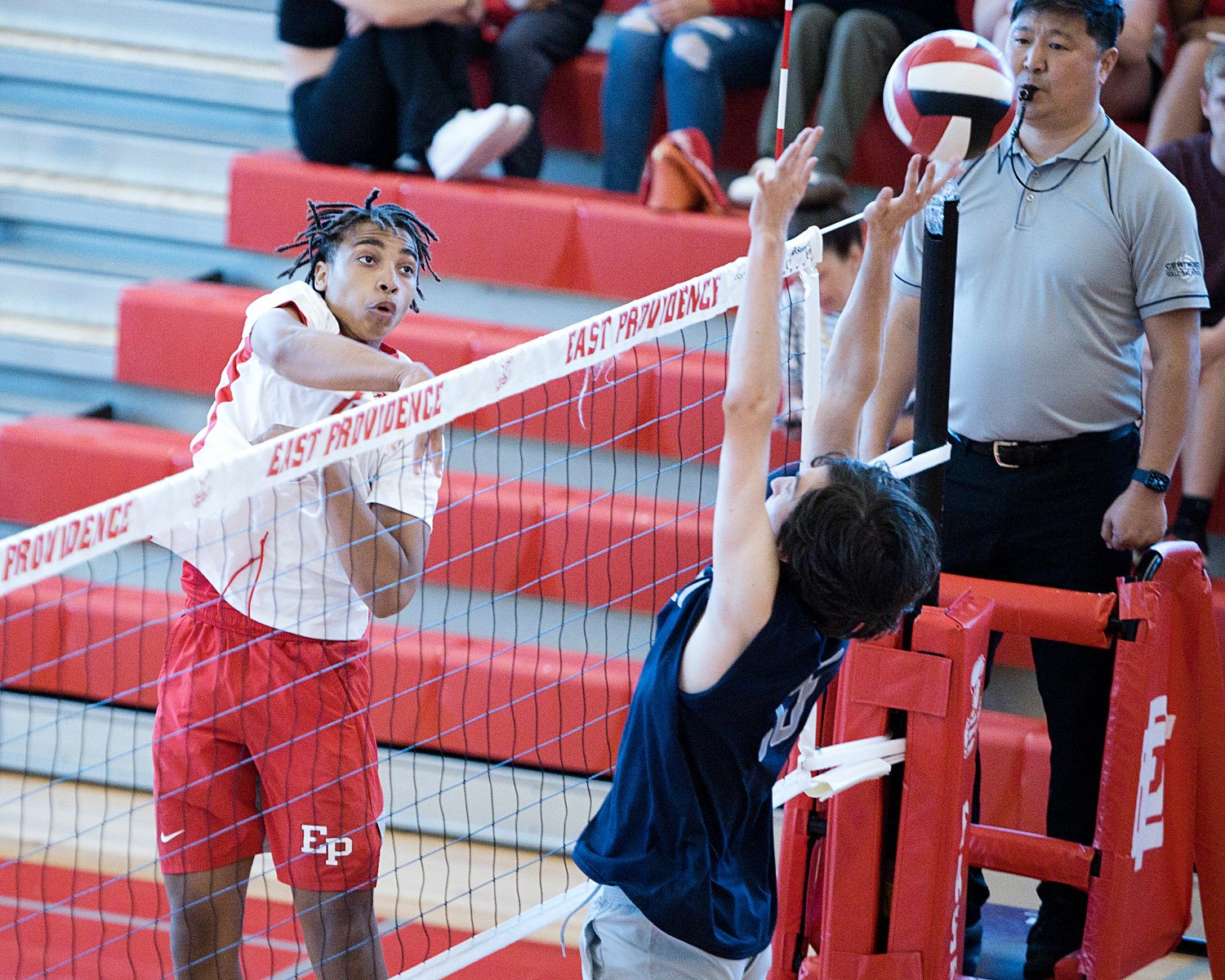 East Providence High School’s Xavier Hazard sends a hard spike over a Westerly opponent.
