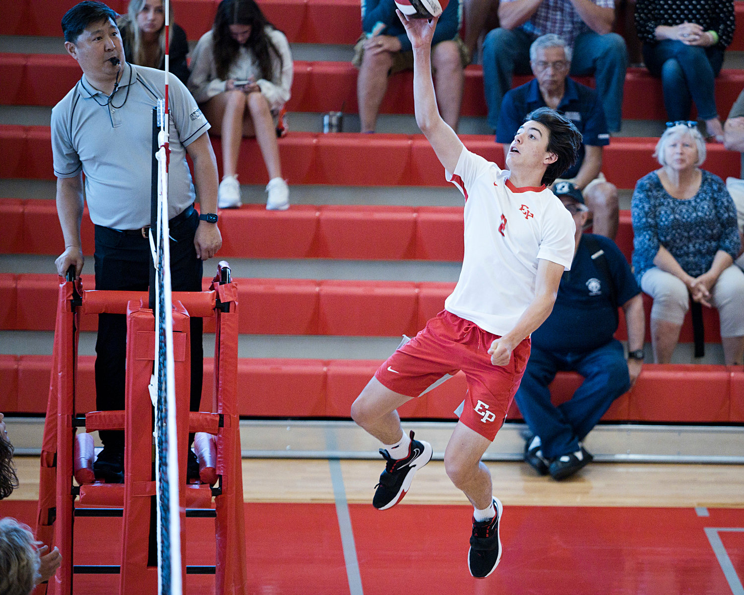 East Providence High School’s Brett Schwab leaps, sending a hard shot to the Westerly side of the net.