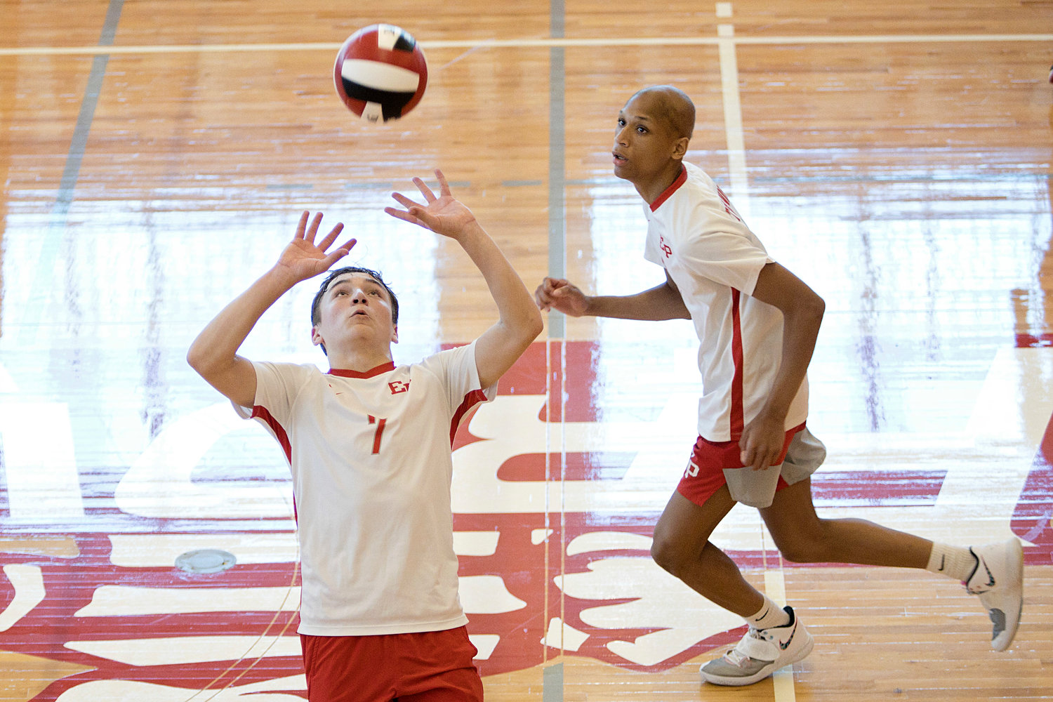 East Providence High School’s D.J. Lepine sets the ball as teammate, Jason Caldwell gets ready for the spike.