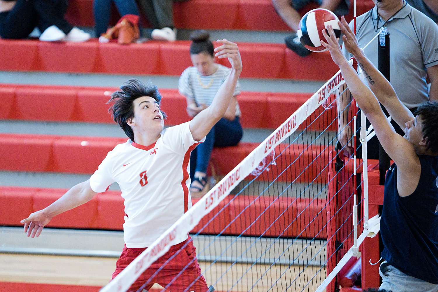 East Providence High School’s Brett Schwab tips the ball over the net while competing against Westerly in the Division II boys' volleyball semifinals, Wednesday, June 8.
