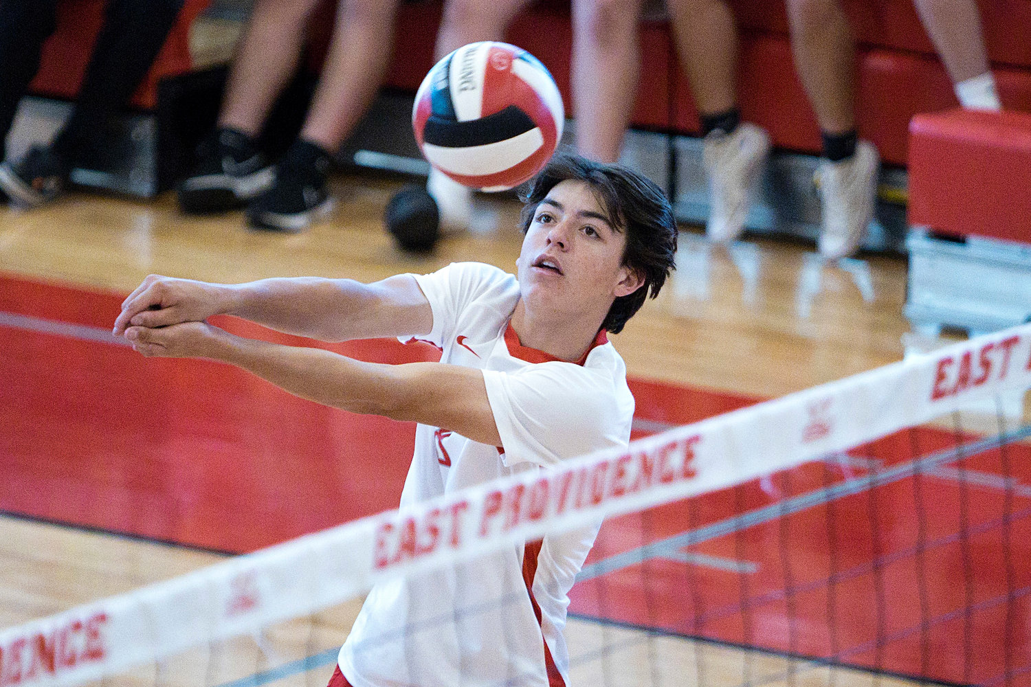 East Providence High School’s Brett Schwab bumps the ball over the net while competing against Westerly in the Division II boys' volleyball semifinals, Wednesday, June 8.