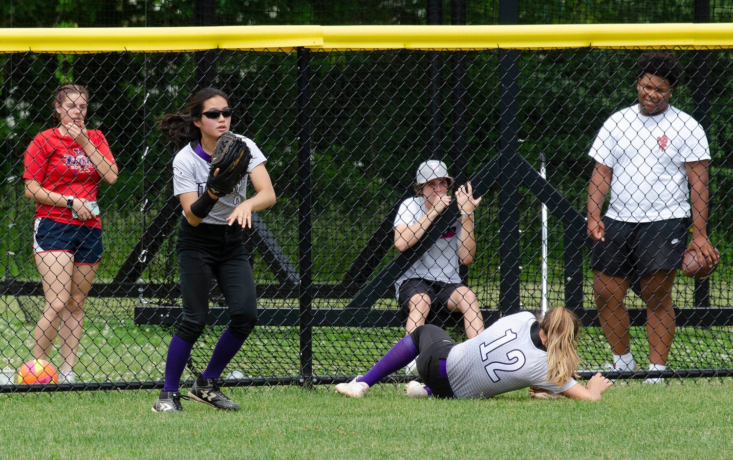 Centerfielder Jayda Sylvia attempts to make a catch of a fly ball hit to the gap in the fifth inning. She slammed into the fence and teammate Elsa White collected the ball and threw it in to prfevent further damage. Sylvia got up, brushed her self off and kept on playing.