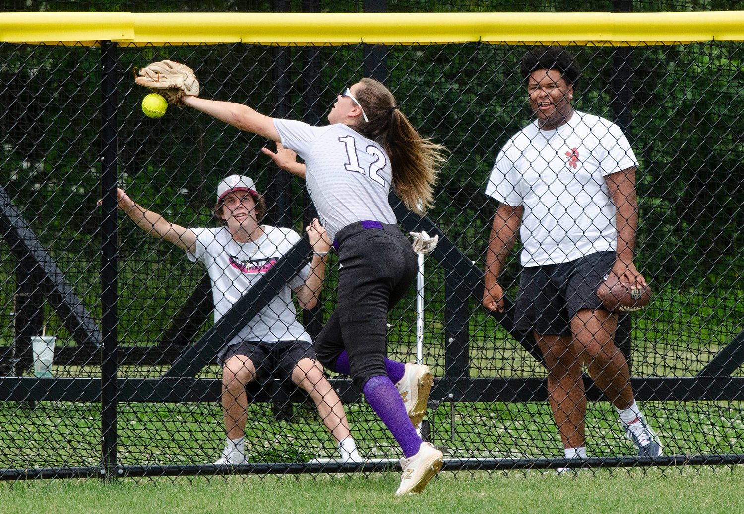 Centerfielder Jayda Sylvia attempts to make a catch of a fly ball hit to the gap in the fifth inning. She slammed into the fence and teammate Elsa White collected the ball and threw it in to prfevent further damage. Sylvia got up, brushed her self off and kept on playing.