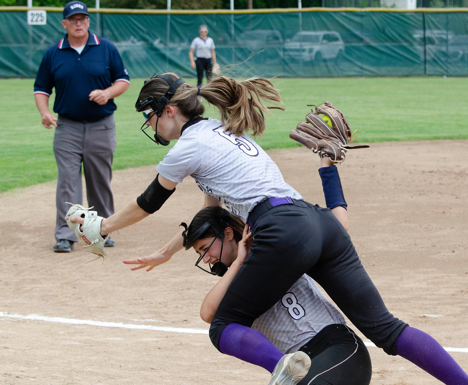 Huskies shortstop Julia Allen makes a catch for the second out of the eighth inning, despite being run over by third baseman Sydney Crowell as she vied for the ball.