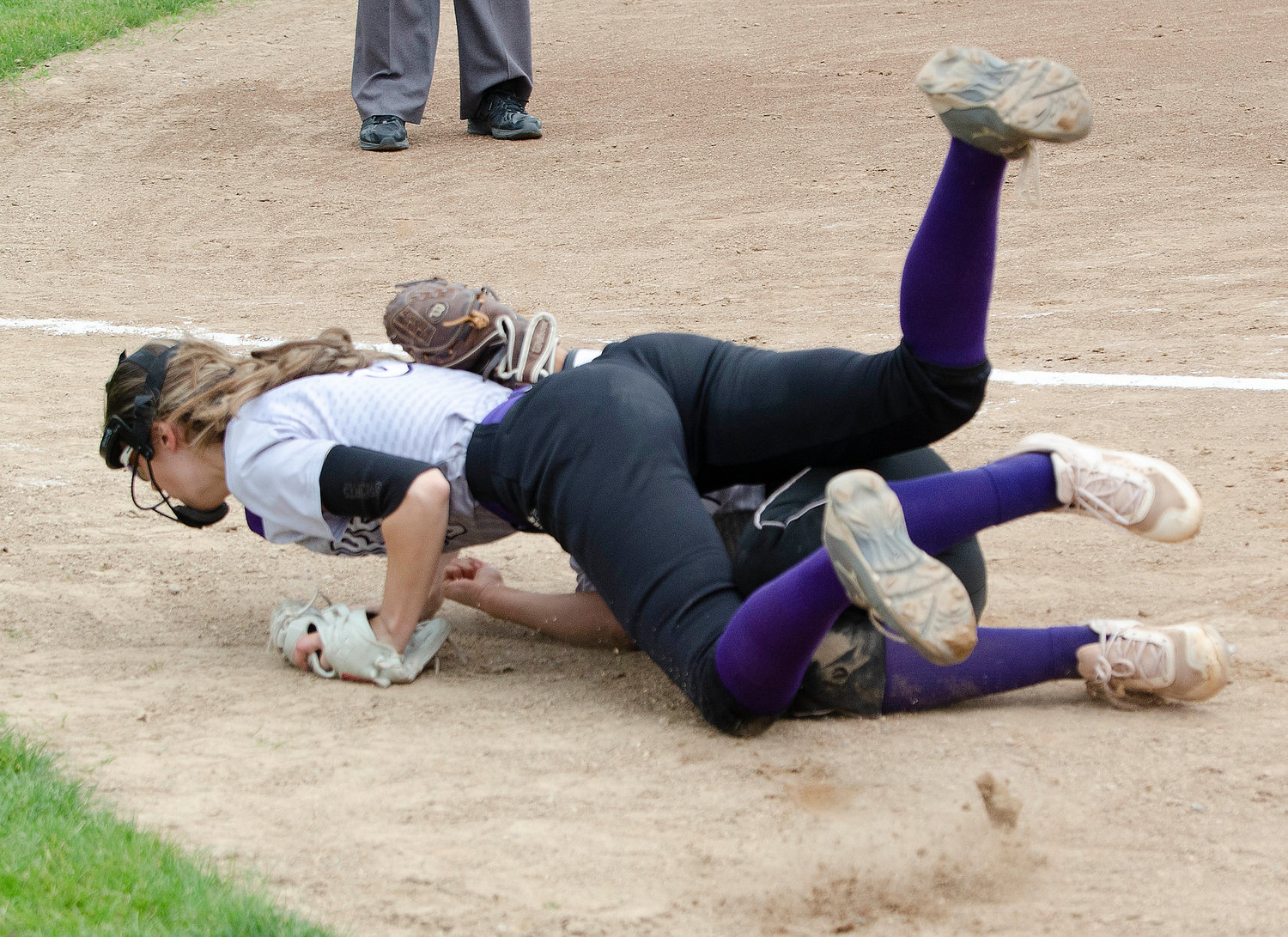 Huskies shortstop Julia Allen makes a catch for the second out of the eighth inning, despite being run over by third baseman Sydney Crowell as she vied for the ball.