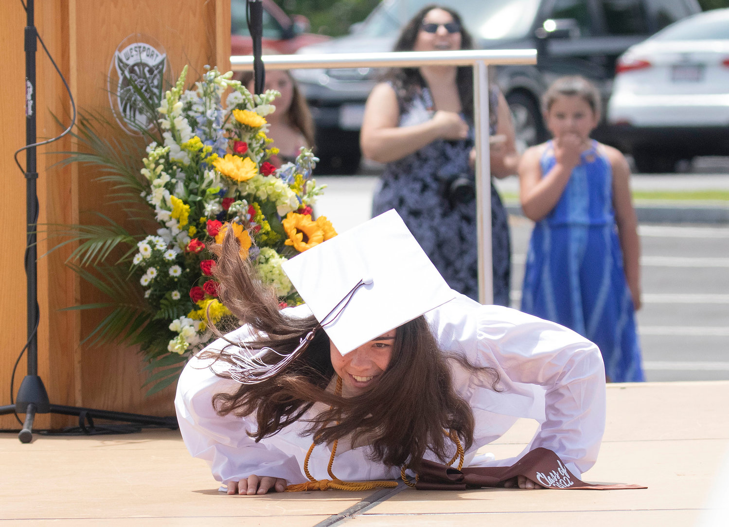Jesse Skov drops and performs pushups on stage before receiving her diploma. 