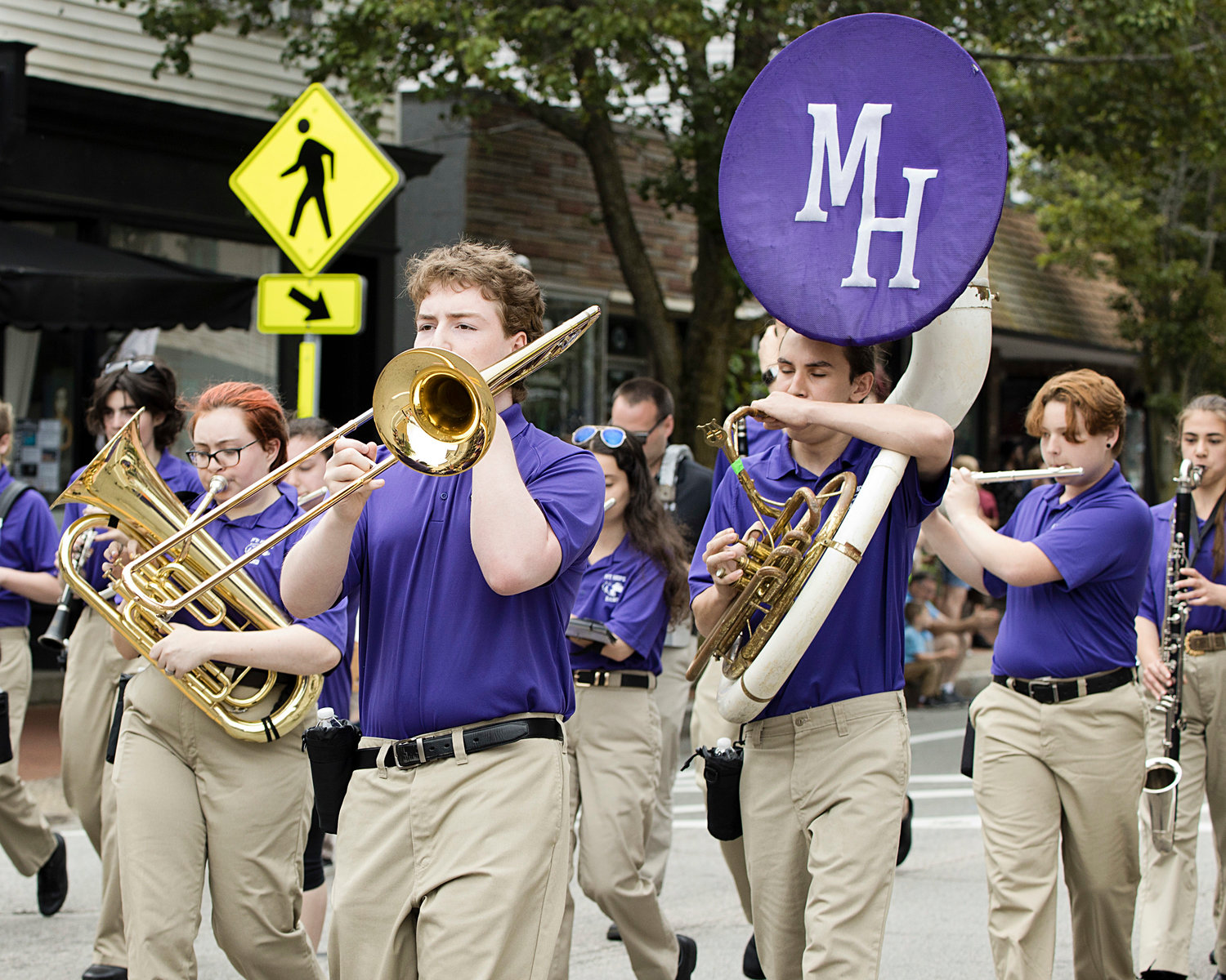 Members of the Mt. Hope High School Marching Band play a song as they march.