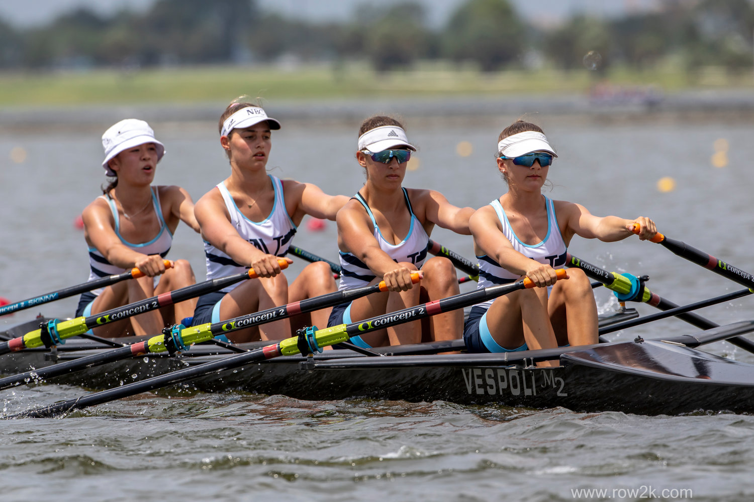 Sophia Haisman, Maude Smith-Montross, Gianna Vigliotti, and Estelle Pivorunas (from left to right) move their boat through the water at US Rowing Youth Nationals.