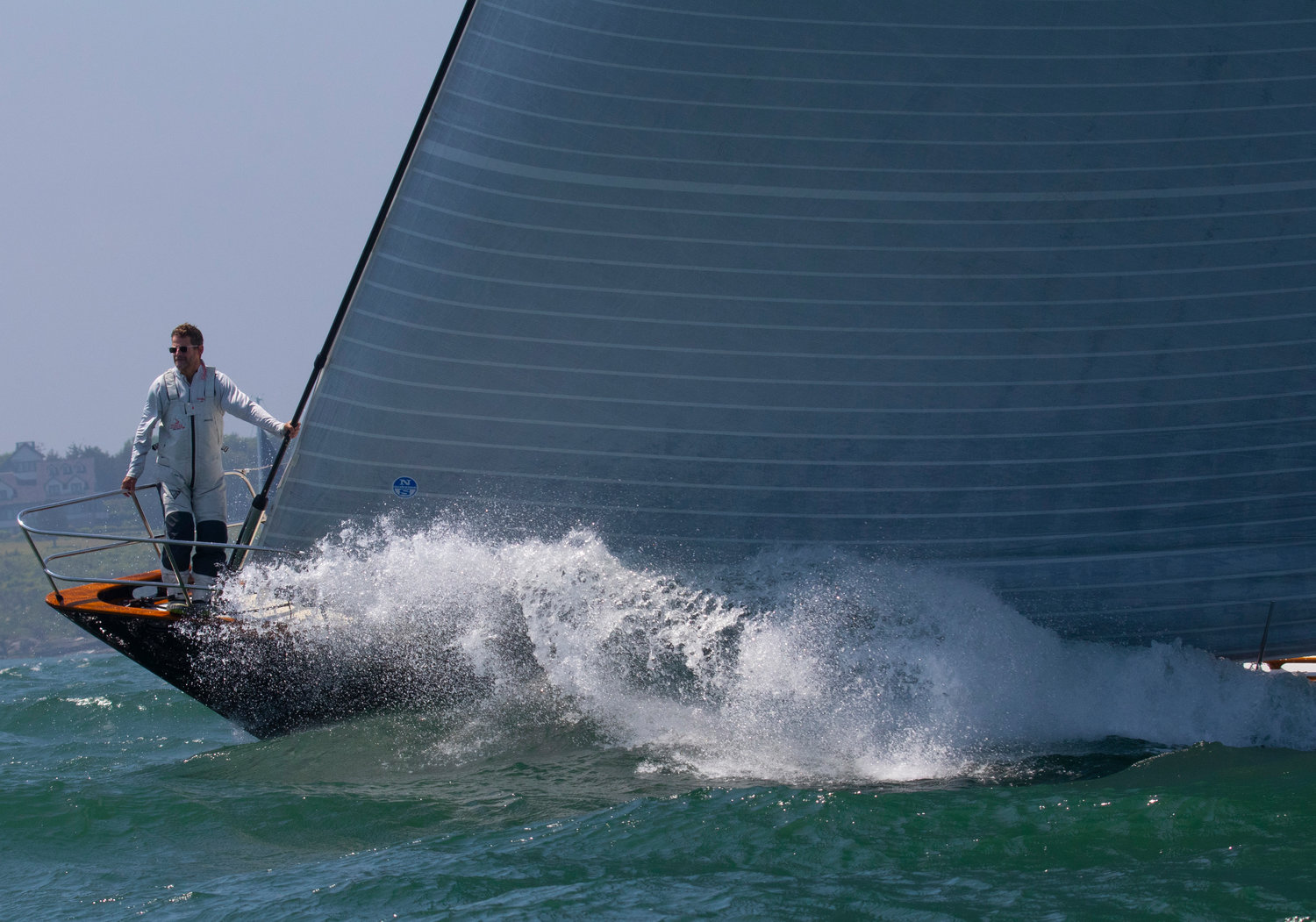 A crewman aboard the Running Tide checks the course as rog rolled into Newport harbor during the race.