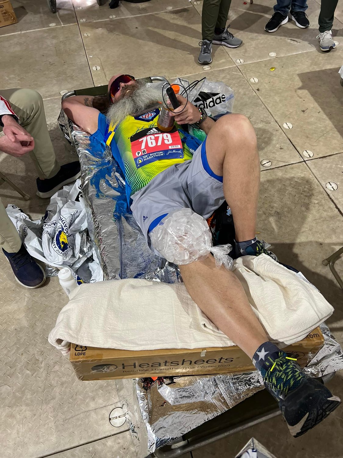 Sanchas ices his knee down after completing the 126th Boston Marathon.