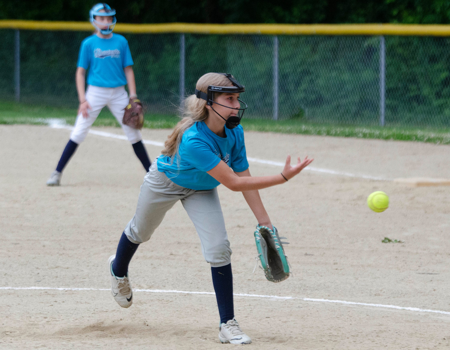 Amelie Bruneau fires a strike toward the plate for Navigant during the Barrington Little League softball minors division finals.