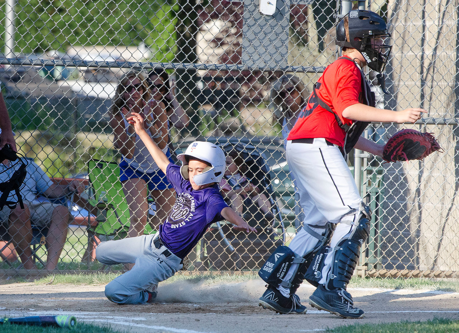 Pinch runner Dylan Cote slides into home plate to score Bristol-Warren's first run of the game in the second inning. 
