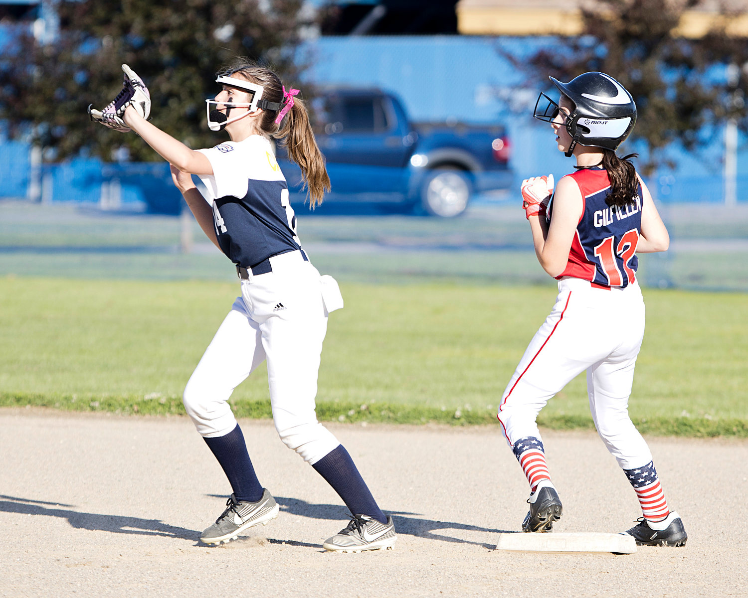 A Tiverton runner sneaks onto second base while Barrington's Lucy Cabral waits for the ball to come her way.