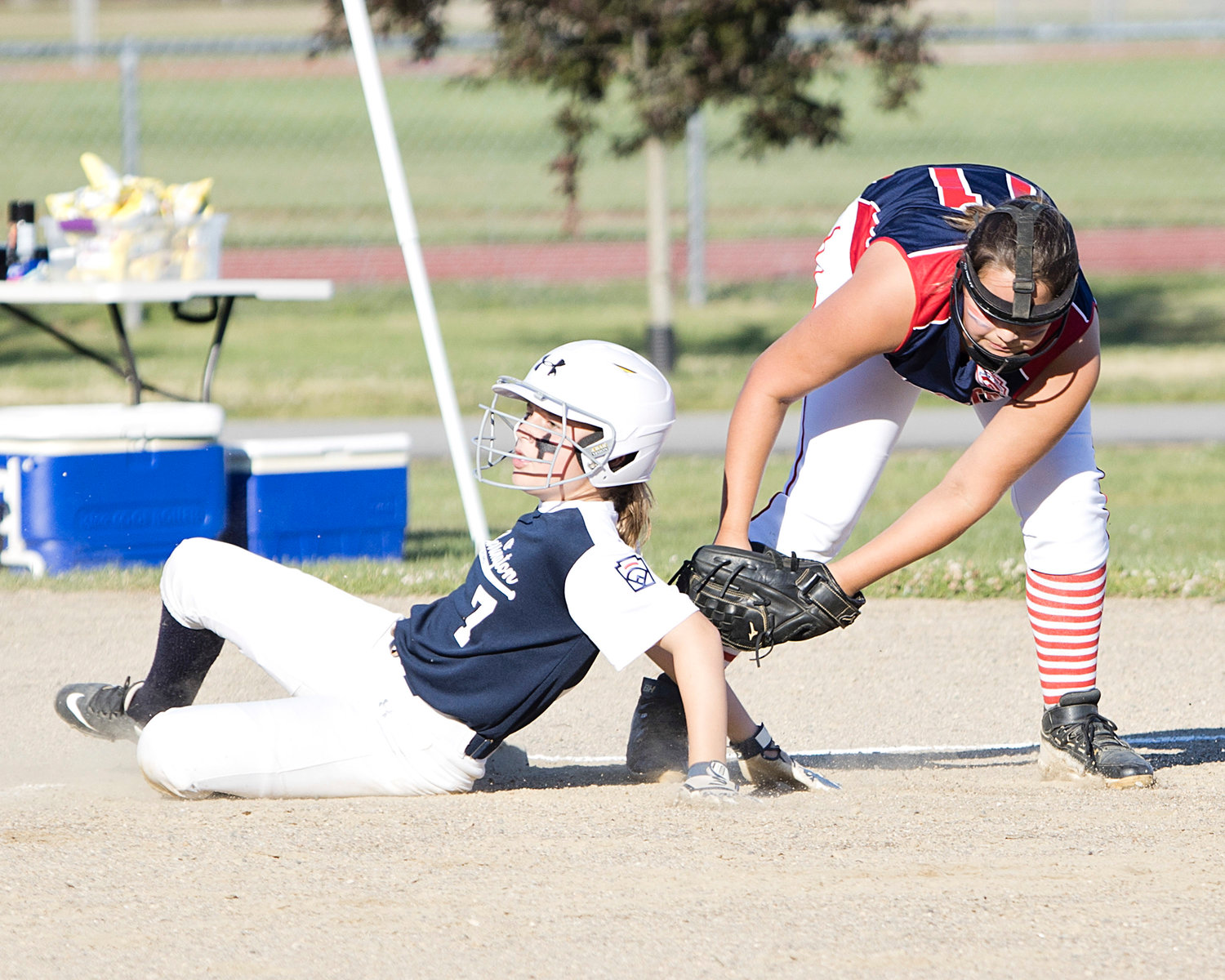 Audry Paxton is tagged by a Tiverton opponent as she slides into third base.