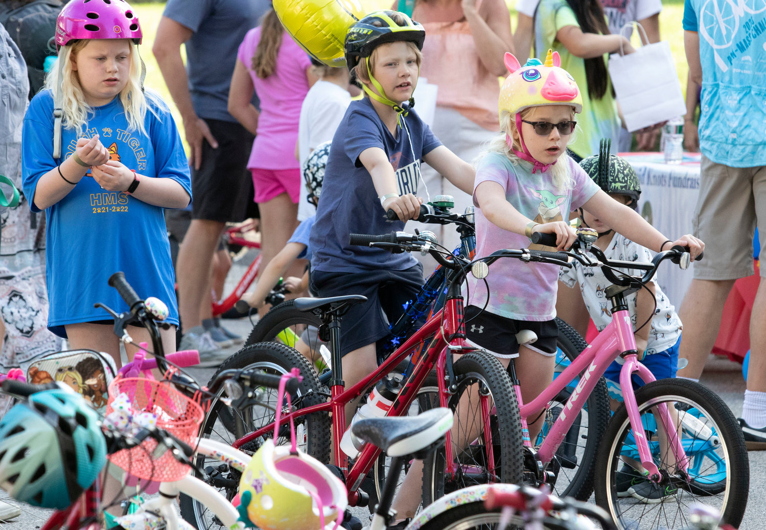 Anna Streit, 11, Louie Fisher, 9, and Clara Streit, 7, sign up for the ride.