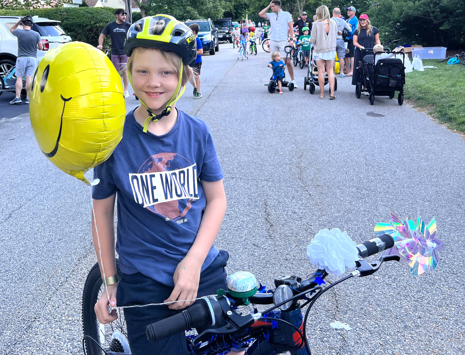 Louie Fisher, 9, holds up the balloon that his mom attached to his bike.