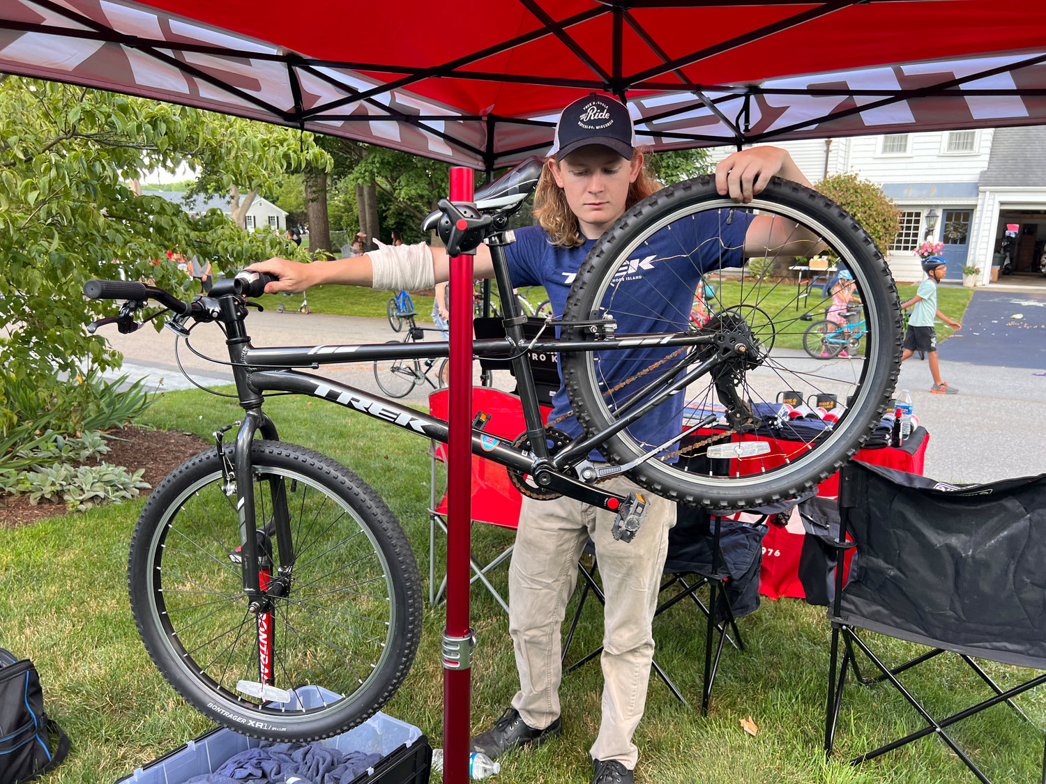 Trek bike specialist Ben O'Neil tunes up a bike in a yard on Fairway Drive. The Trek store in EP is sponsoring the Pan Mass racers.