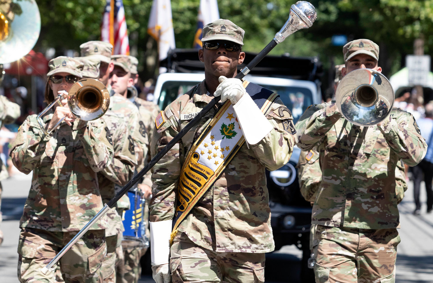 SSG John Richards (center) of Governor's Own 88th Army Band leads the band down Hope Street.