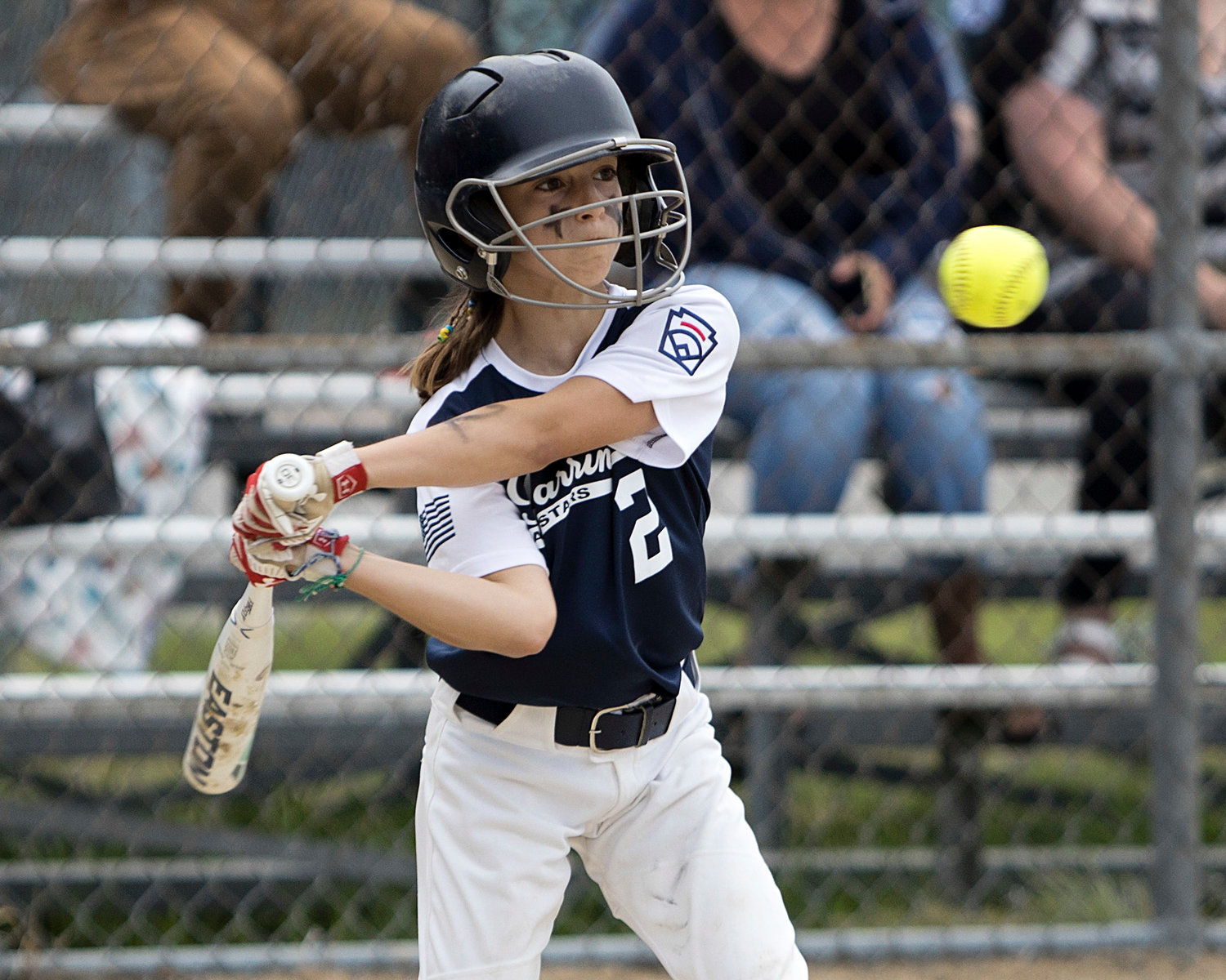 Angie Promades watches the ball as she goes up to bat against Middletown in the first inning of the Minors Division Softball All-Stars, Tuesday.