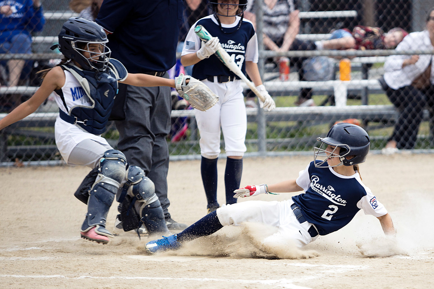 Angie Promades slides safely into home plate during the second inning of Tuesday's playoff game, against Middletown.