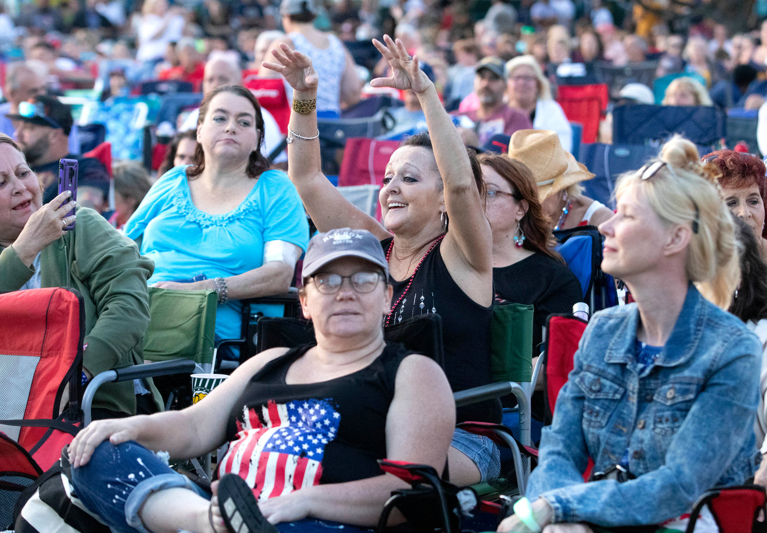 Jocelyn Oliveira (center) and others cheer as the band plays Bon Jovi's "Living on a Prayer."