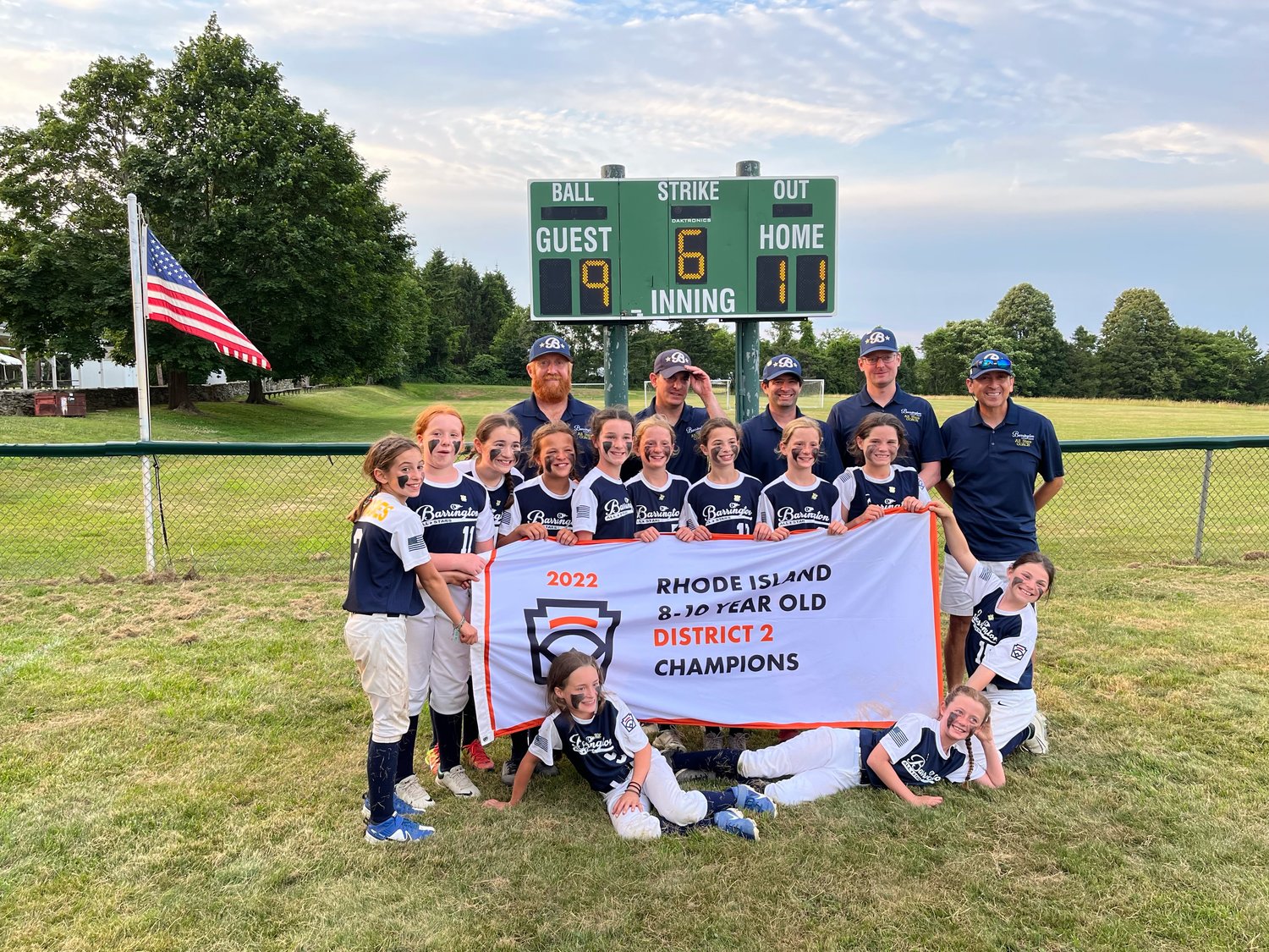 Members of the Barrington Minors Division All-Star softball team hold up the District 2 Champions banner following their win over Portsmouth on Friday night.