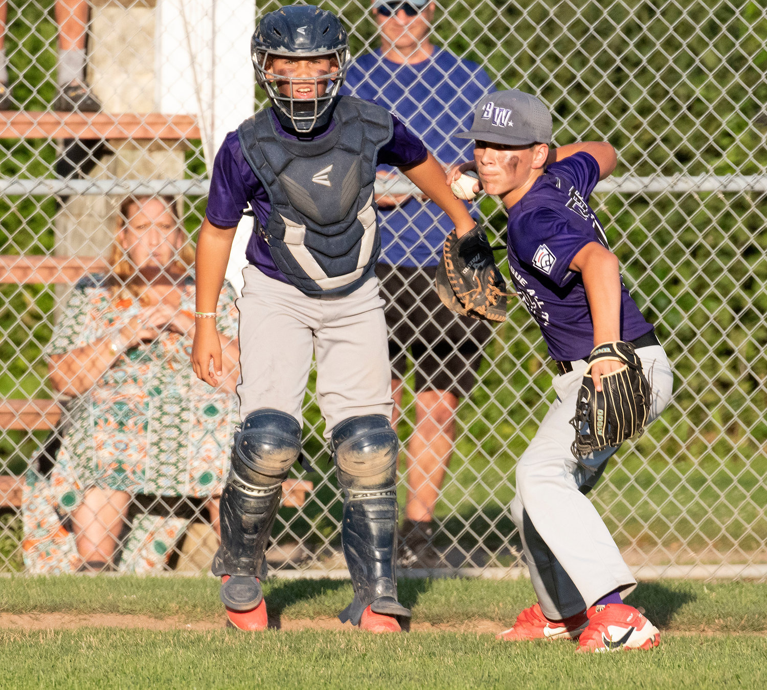 Bristol-Warren catcher Ryan Thompson looks on as pitcher Michael Towers fields a bunt during the game.