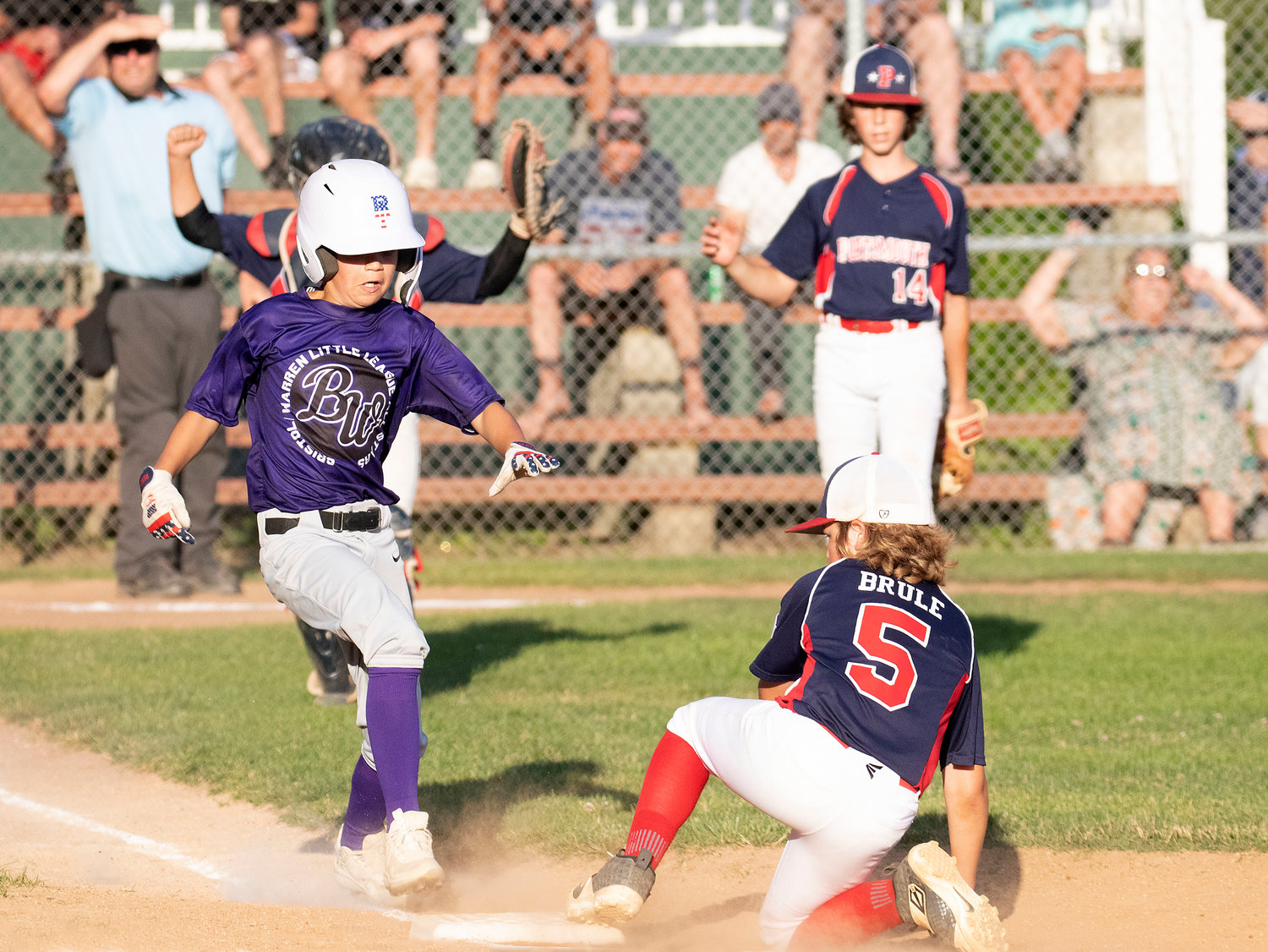 Second baseman Kane Brule (right) gets his foot on the bag before Bristol-Warren’s Reed Dubois (left) after he laid down a bunt to lead off the fifth inning.