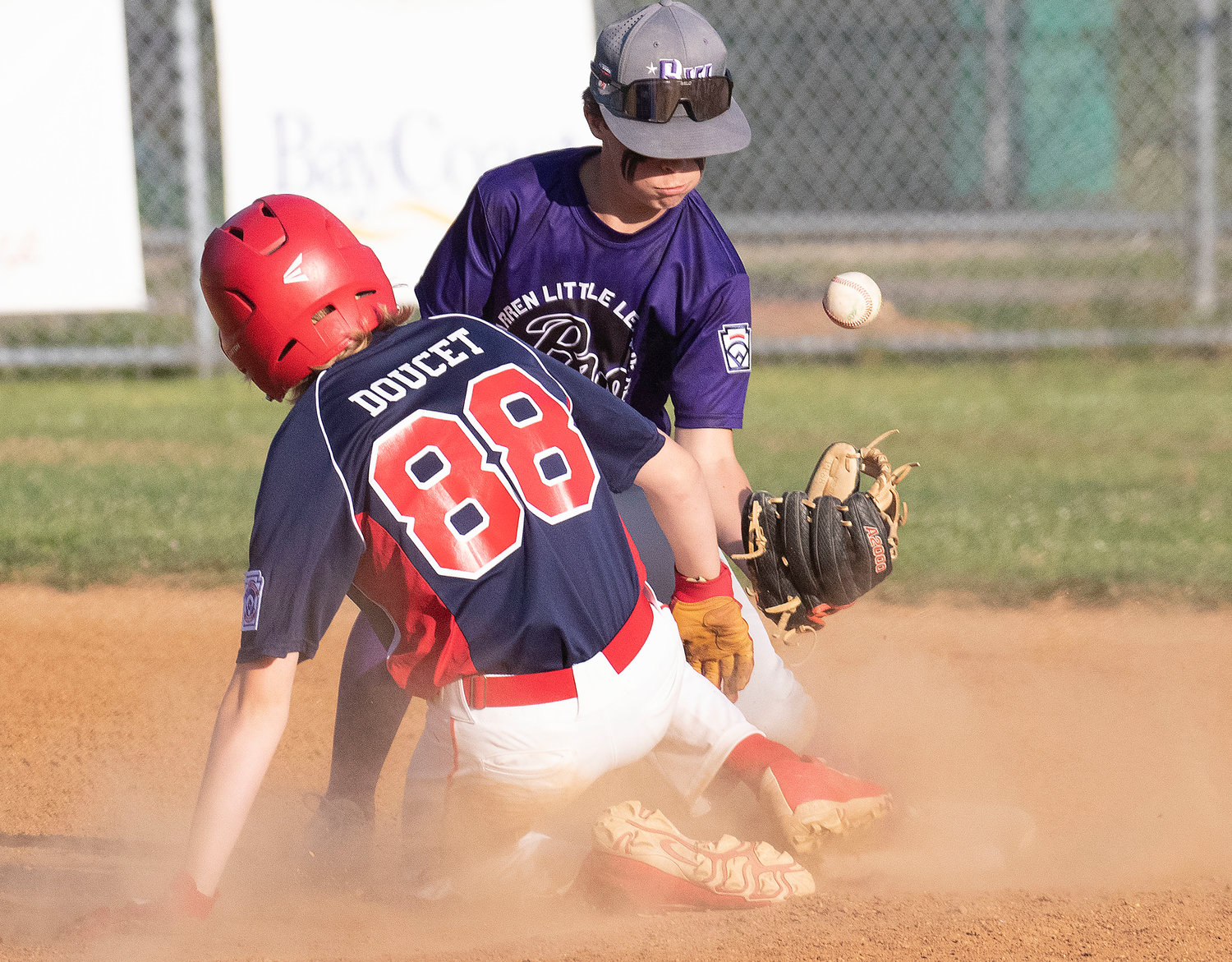 Shortstop Parker DeWolf bobbles a throw from the outfield as Tyler Doucet slides safely into second bases.