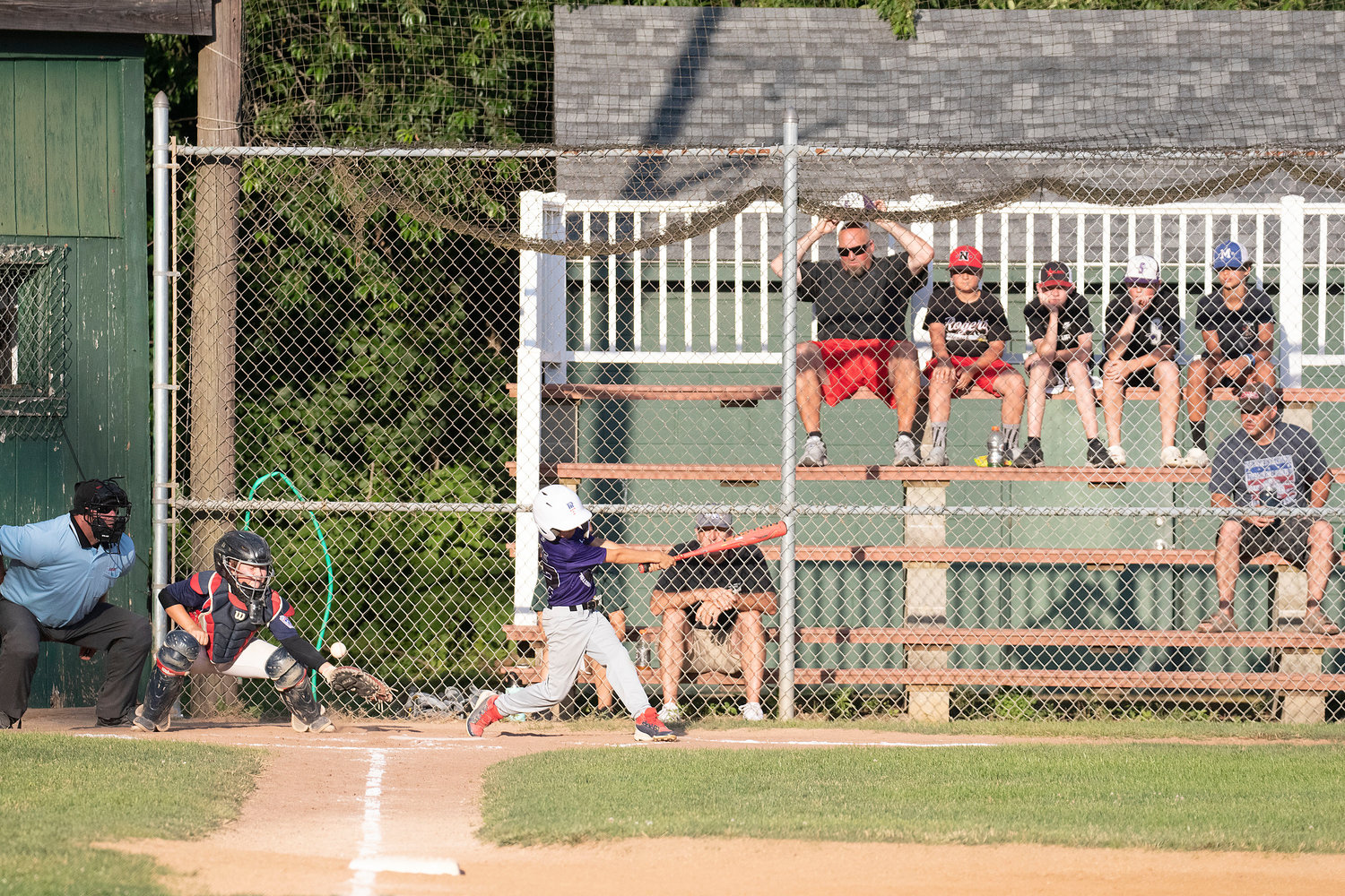 Fans react as pinch hitter Dylan Cote Swings at a pitch by Ben Humm. Catcher Ryan Campion is (left).