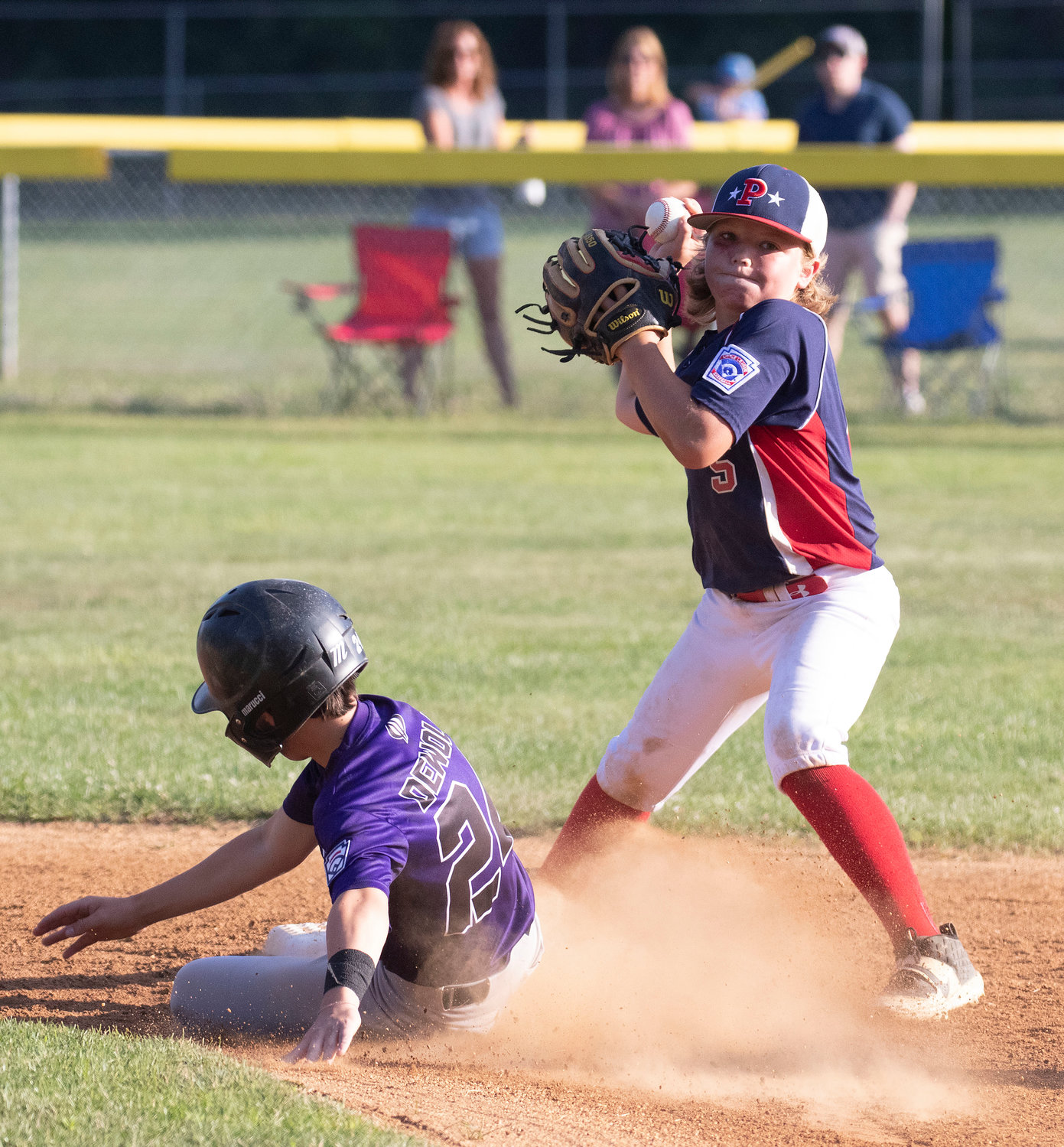 Parker DeWolf slides into second base as Portsmouth second baseman Kane Brule attempts to turn a double play.