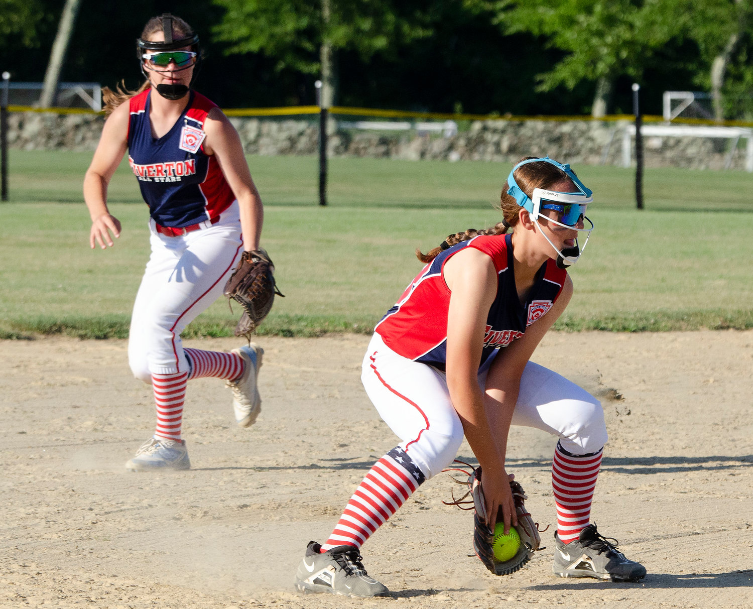 Shortstop Elodie Cannon (looks on as third baseman Paisley Parisee catches a ground ball in the first inning.