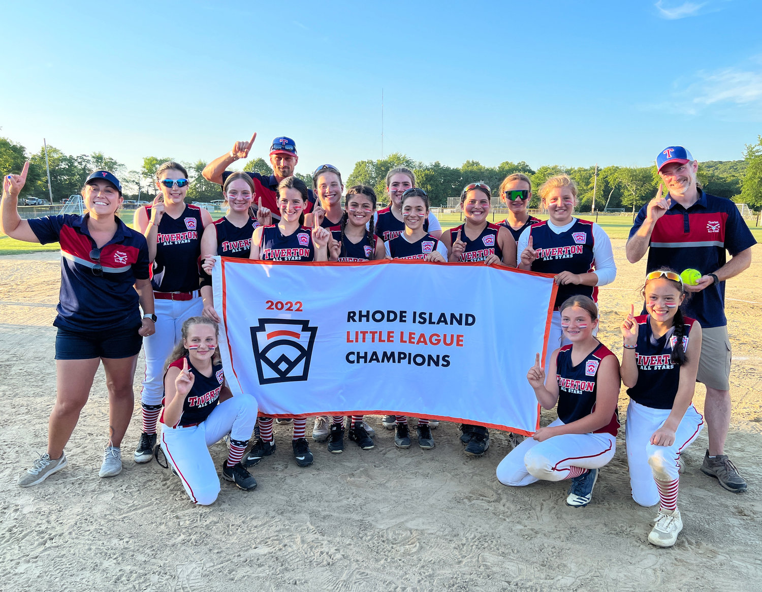 The Tiverton 11-12U all stars pose with the state championship banner after beating South Kingstown 2-0 in a best of three series at Town Farm Field on Wednesday night.