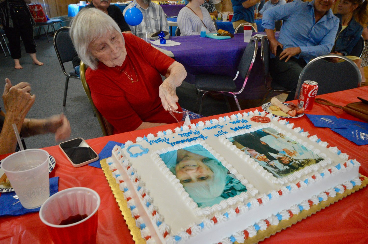 Mary Martin slices the first piece of cake at her birthday party inside the FOP Lodge.