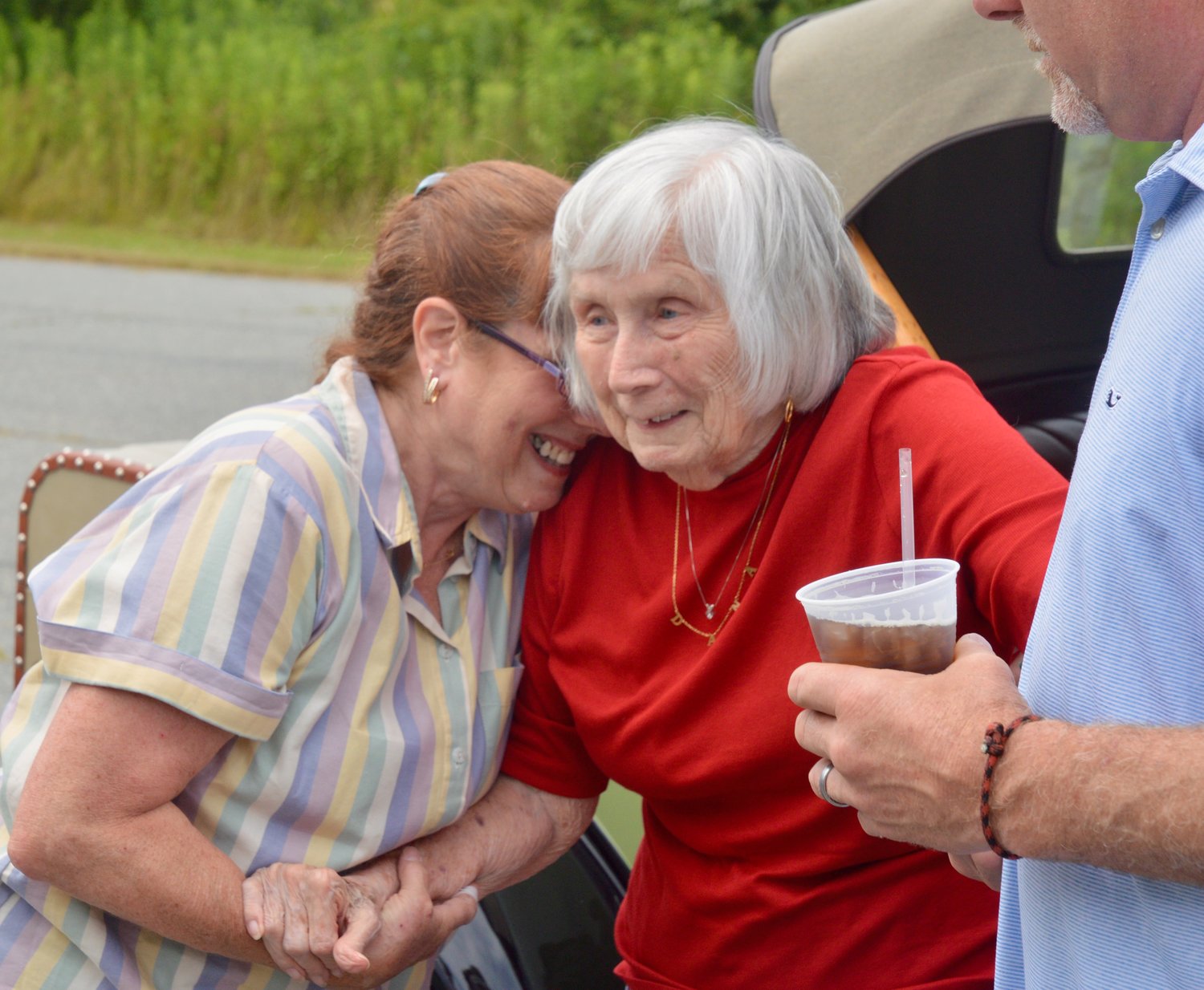 Leilani Beaudry (left) welcomes her mom, Mary Martin, upon her arrival to the party.