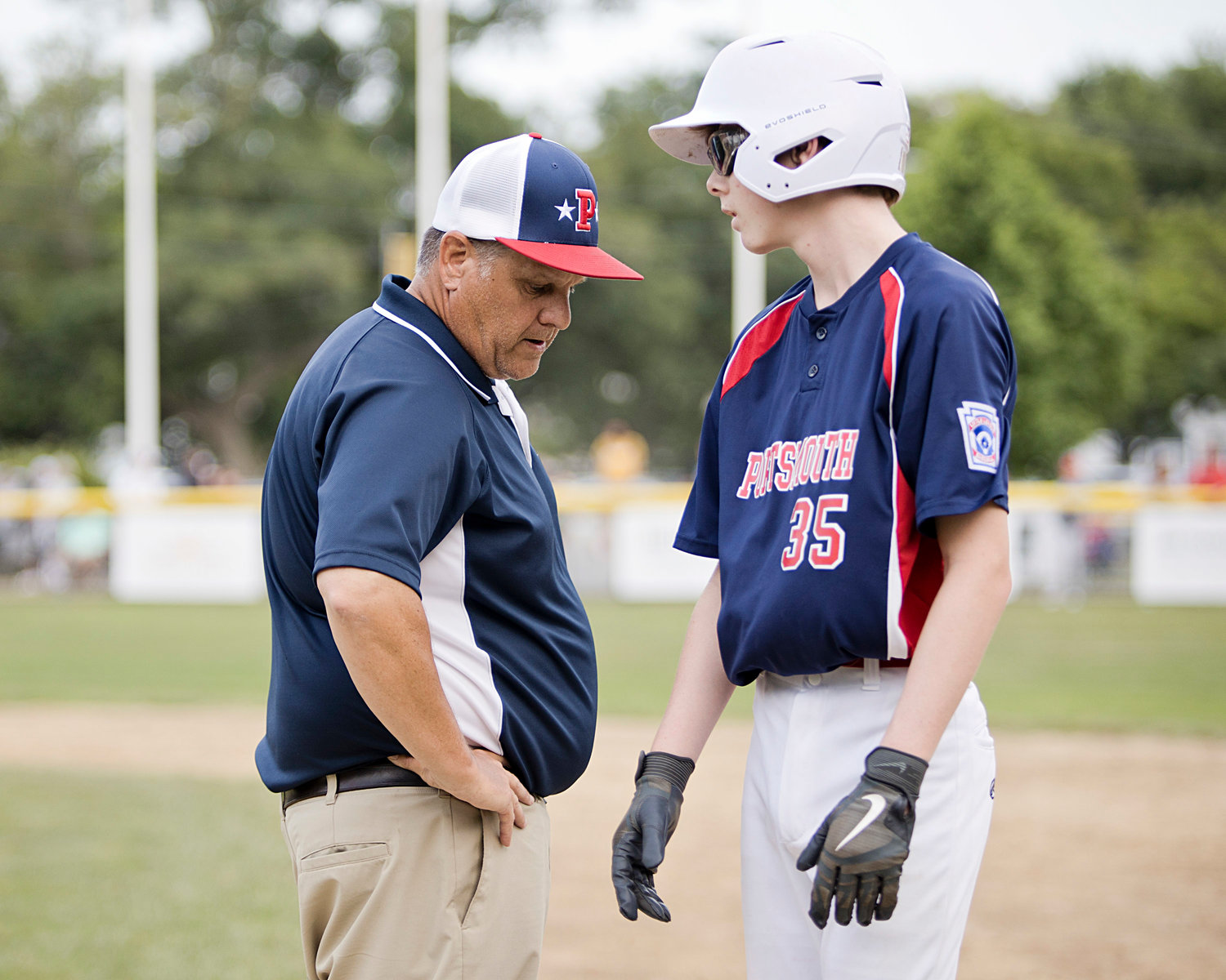 Tyler Boiani takes some advice from manager Bob Campion while standing on first base.