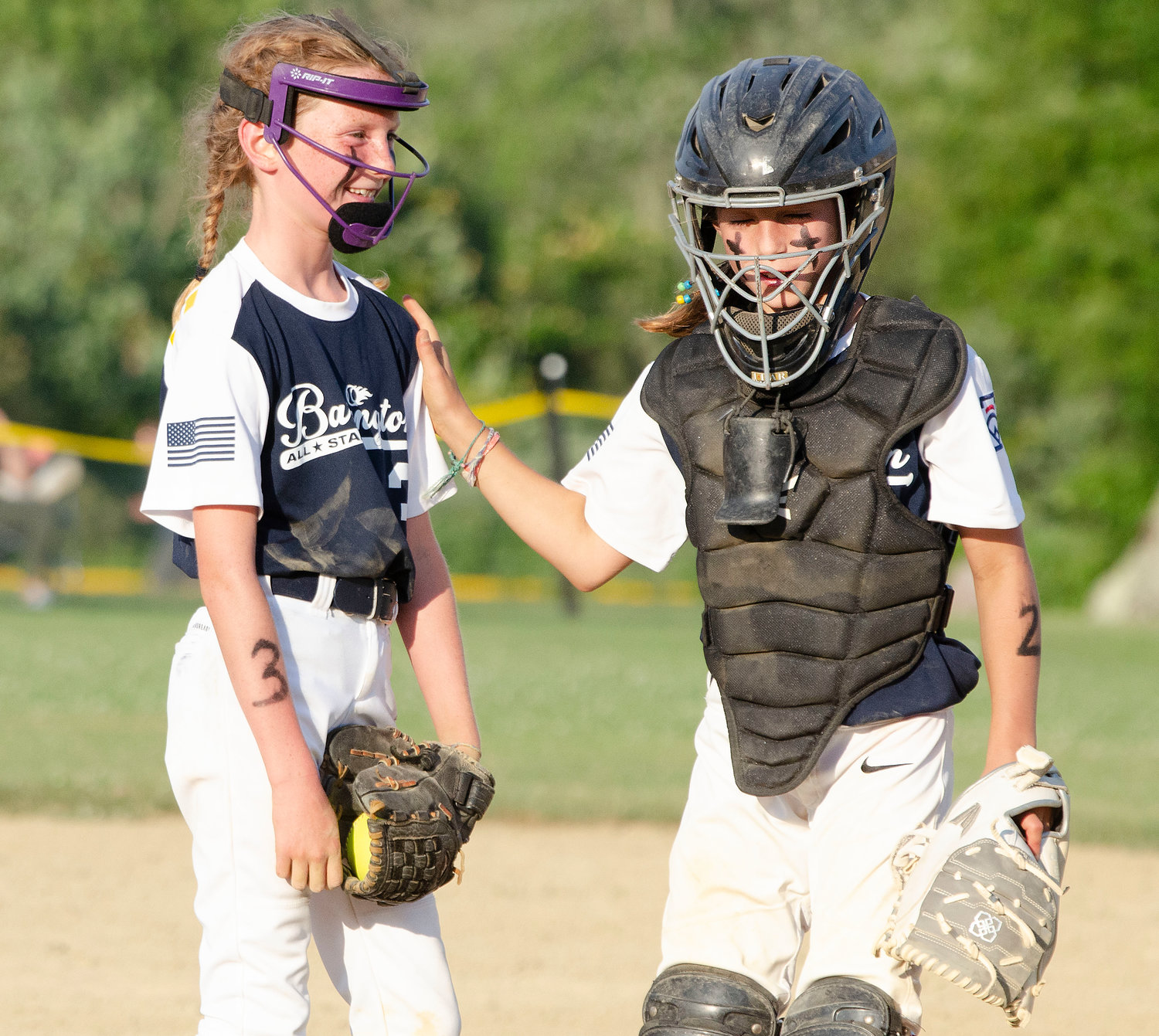 Catcher Angie Promades (right) talks to pitcher Lucy LoVerme during Barrington's game against Cranston Western.