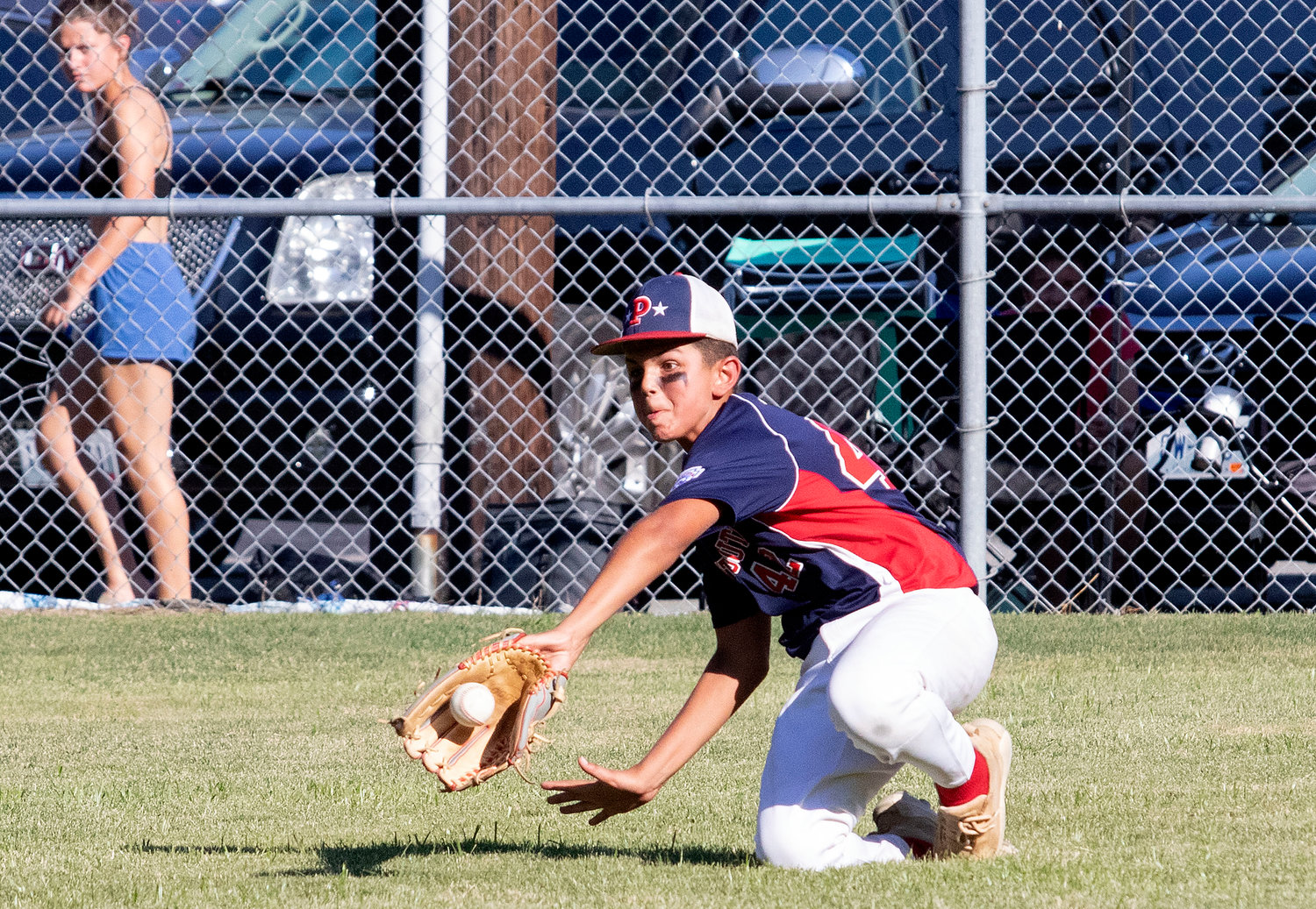 Riven Patel slides in to make an across-the-body catch to make the first out of the sixth inning against Cumberland on Saturday during the state Little League tournament.