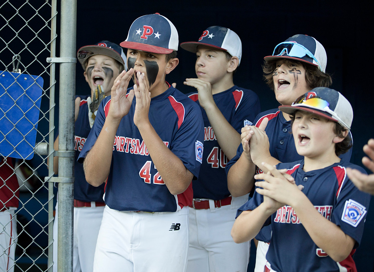 Portsmouth players amp each other up in the dugout before the start of the state championship game against Cumberland.