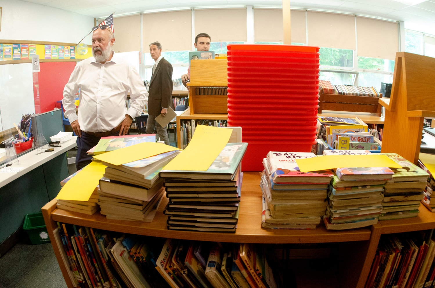 Joseph DaSilva, the coordinator for the state’s school building authority, (left) tours the library at Nayatt School.