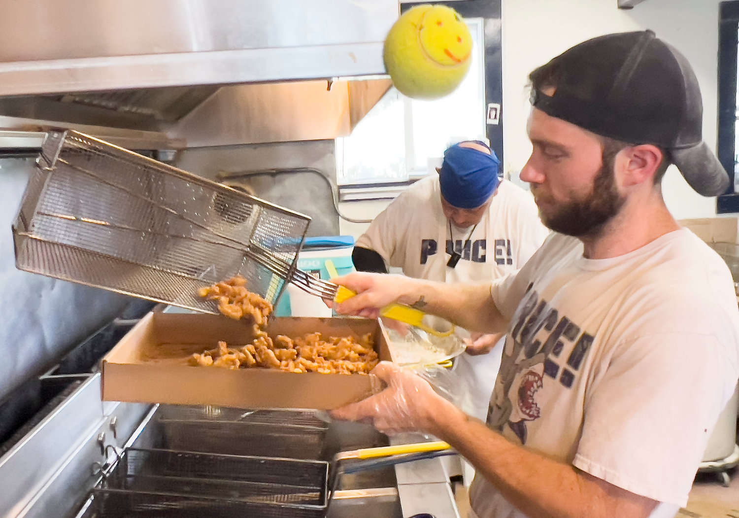 Will Walker runs a batch of fries through the fryolator at Flo’s Drive-In.
